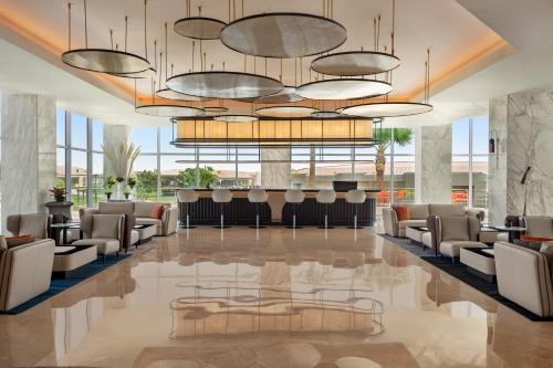a lobby with chairs and a bar in a building at Pickalbatros Golf Luxury Suites - All Inclusive in Sharm El Sheikh
