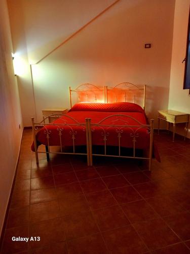 a bedroom with a red bed in a room at Dimora Montenegro 