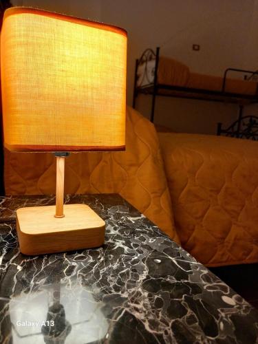 a lamp sitting on top of a table next to a couch at Dimora Montenegro 