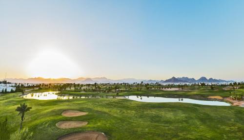 a view of a golf course with a pond at Pickalbatros Golf Luxury Suites - All Inclusive in Sharm El Sheikh