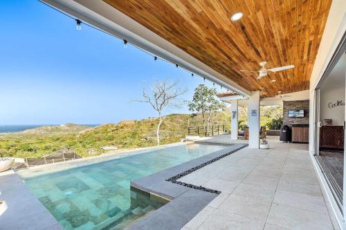 an indoor swimming pool with a wooden ceiling at Ocean View Villa & Private Pool in Mar Vista in Brasilito