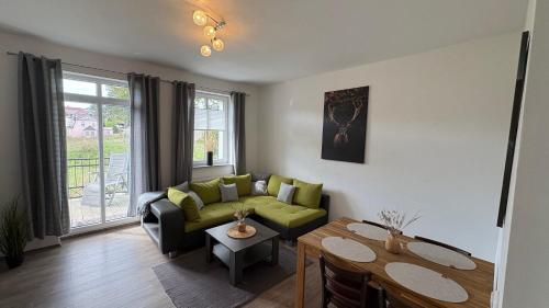 a living room with a couch and a table at Haus am Röblinsee - Ferienwohnungen in Fürstenberg in Fürstenberg-Havel