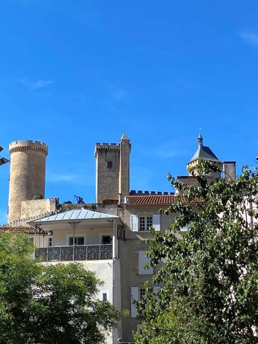 a building with two towers on top of it at 3 pièces spacieux plein centre, parking,clim, terrasse, jardin in Foix