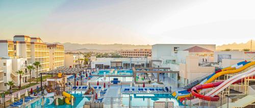 a large swimming pool with a water park with slides at Amarina Abu Soma Resort & Aquapark in Hurghada