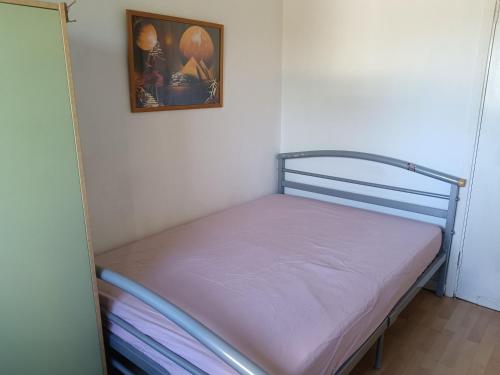 a small bed in a room with a picture on the wall at Glasgow St George's Room in Glasgow