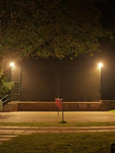 a wall with two street lights and a red flag at Vythiri Resort in Vythiri
