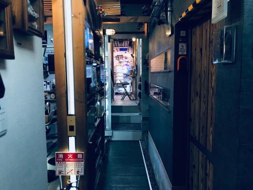 a hallway of a room with a stairway in a building at Koke Musu inn in Otsu