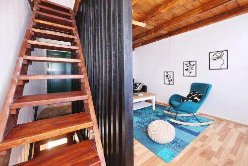 a staircase in a room with a chair and a desk at Holiday Home Tranquilla with heated pool in Blato