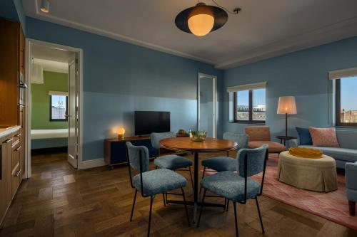 a living room with a table and chairs and a couch at The July - Twenty Eight in Amsterdam