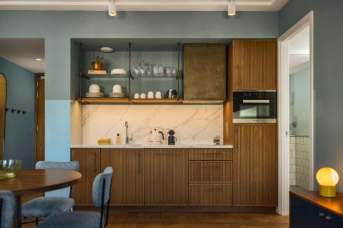 a kitchen with wooden cabinets and a table at The July - Twenty Eight in Amsterdam