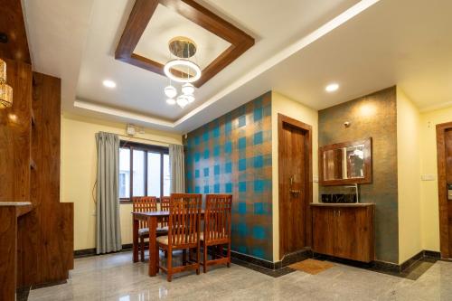 a dining room with a table and chairs at SID Royale in Gachibowli