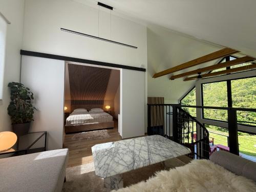 a living room with a bed and a couch at Mátramélye Vendégház in Parád
