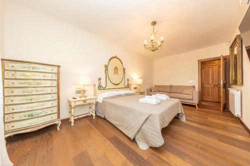 a bedroom with a bed and a couch and a dresser at Mas Xibeques in Báscara