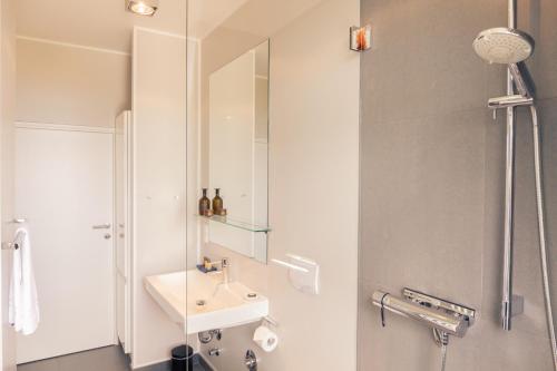 a bathroom with a sink and a mirror at OSTKÜSTE - Villa Albatros Design Apartments in Ahlbeck