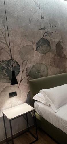 a bedroom with a bed and a wall mural at Hotel La Rocca in San Marino