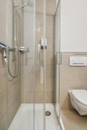 a bathroom with a shower and a toilet at UP&GREAT Apartments - Chic Urban Homes in Zürich