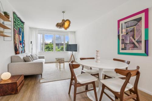 a living room with a table and a couch at UP&GREAT Apartments - Chic Urban Homes in Zürich