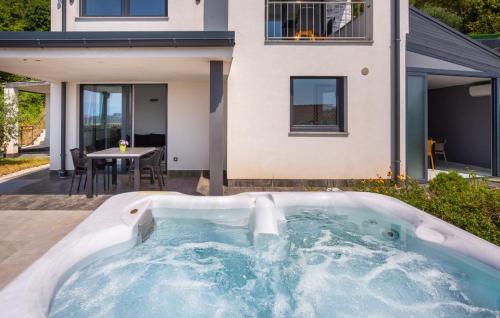 a hot tub in the backyard of a house at Villa Nada sea view&whirpool island Krk by Villas in Omišalj