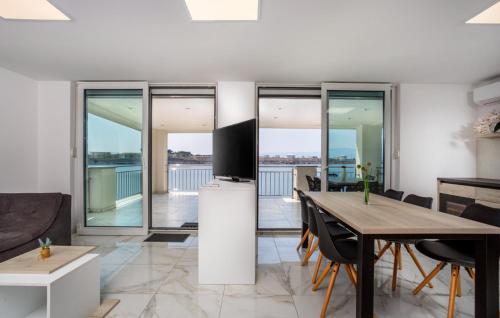 a living room with a table and a television at Villa Nada sea view&whirpool island Krk by Villas in Omišalj