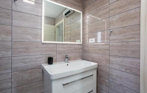 a bathroom with a sink and a mirror at Villa Nada sea view&whirpool island Krk by Villas in Omišalj