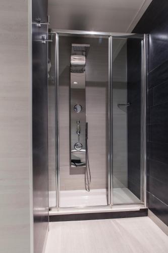 a shower with a glass door in a bathroom at Hotel Diagonal Plaza in Zaragoza