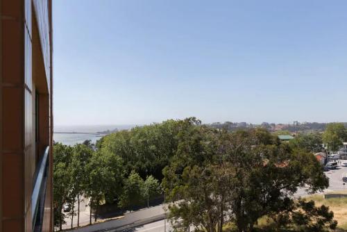 a view of the water from a building at Spacious 1BR with Parking in Quiet Area in Vila Nova de Gaia