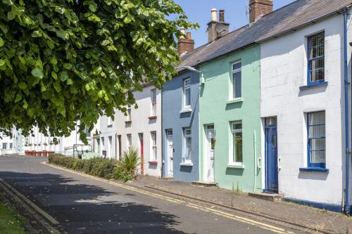 a row of colorful houses on a street at Joymount Cottage in Carrickfergus
