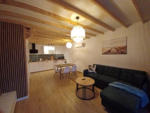 a living room with a couch and a table at Błękitne Zamorze i Domki Premium Niechorze in Niechorze