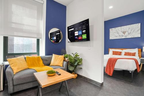 a living room with a couch and a bed at CozySuites Chic1BR in Downtown Pitts #11 in Pittsburgh