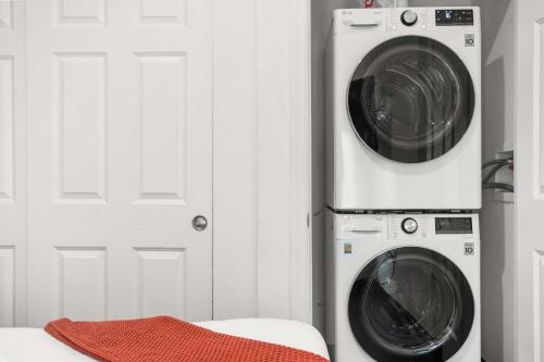 a washing machine and a dryer next to a door at CozySuites Chic1BR in Downtown Pitts #11 in Pittsburgh