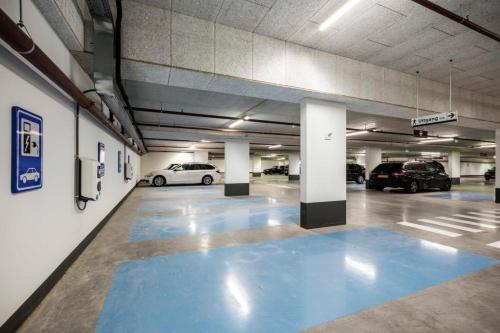 a parking garage with two cars parked in it at The July - Twenty Eight in Amsterdam