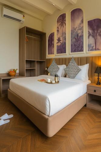 a bedroom with a large bed in a room at Aarambh By The Sky Imperial, Nathdwara in Nāthdwāra