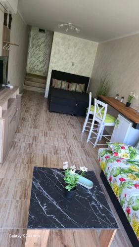 a living room with a couch and a table at Студио за гости Перла in Belogradchik