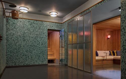 a hallway with green tiled walls and a living room at The July - Twenty Eight in Amsterdam