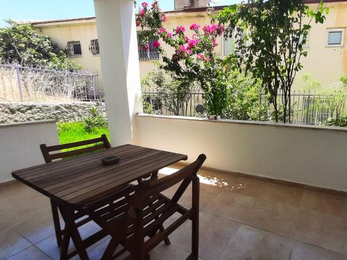 a wooden table and two chairs on a patio at #481 - Spacious 3BR Duplex with Private Garden in Datca