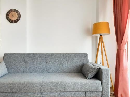 a couch in a living room with a lamp and a clock at #481 - Spacious 3BR Duplex with Private Garden in Datca