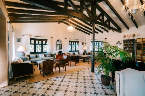 an open living room with couches and tables at Hotel Son Molí Country House in Playa de Palma