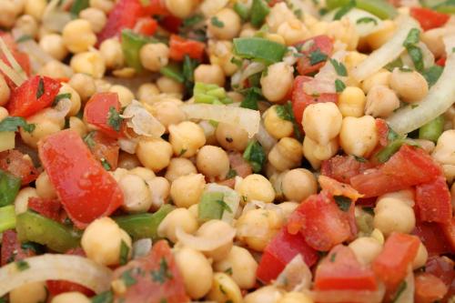 a salad with chickpeas and vegetables on a plate at Villa Marie in Courçon