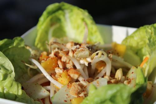 a salad with lettuce and dressing in a white bowl at Villa Marie in Courçon
