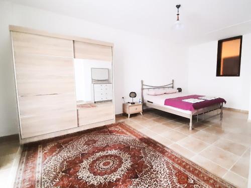 a bedroom with a bed and a large glass cabinet at #481 - Spacious 3BR Duplex with Private Garden in Datca