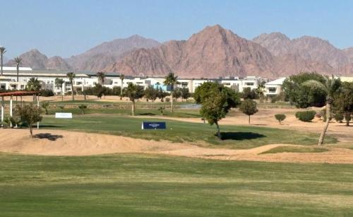 a view of a golf course with mountains in the background at Pickalbatros Golf Luxury Suites - All Inclusive in Sharm El Sheikh