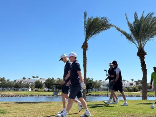 a group of people walking around a golf course at Pickalbatros Golf Luxury Suites - All Inclusive in Sharm El Sheikh