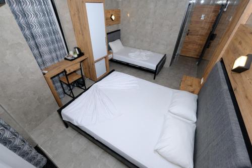 Letto o letti in una camera di M-ODA OTEL