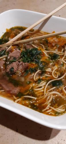 a bowl of food with chopsticks in it at Villa Marie in Courçon