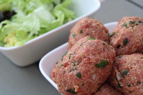 a plate of meatballs and a bowl of salad at Villa Marie in Courçon