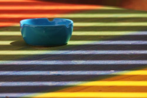 a blue bowl sitting on a colorful rug at Timbuktu Hostel in San Vito lo Capo