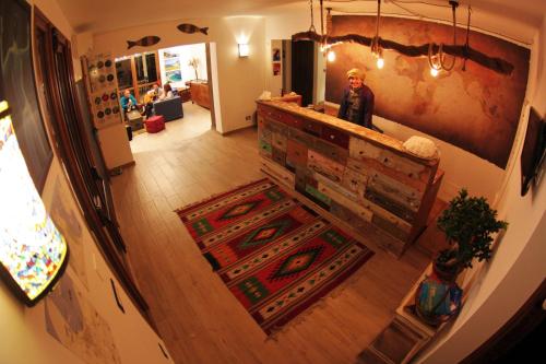 a woman standing at a counter in a room at Timbuktu Hostel in San Vito lo Capo