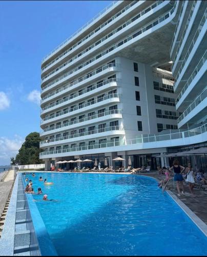 a large swimming pool in front of a large building at Bamboo Beach Tsikhisdziri 347K in Tsikhisdziri