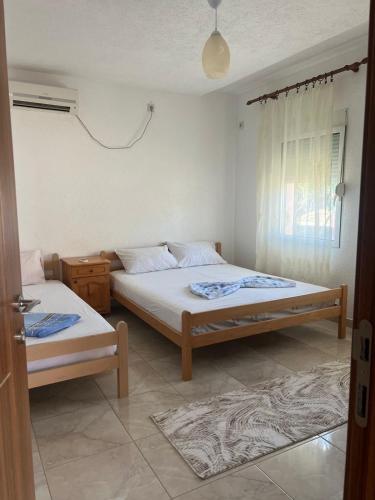 a bedroom with two beds and a window at Haus Binas in Ulcinj