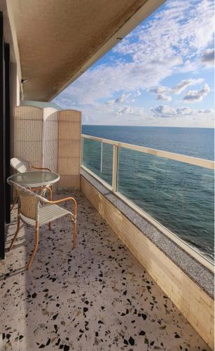 a balcony with a table and a view of the ocean at Bamboo Beach Tsikhisdziri 347K in Tsikhisdziri